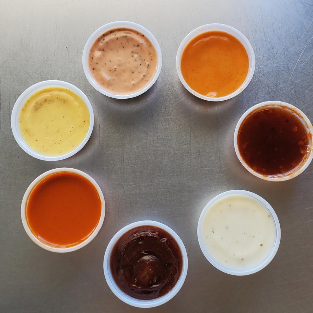 Seven custom signature dipping sauces at Island Chick-N-Shack